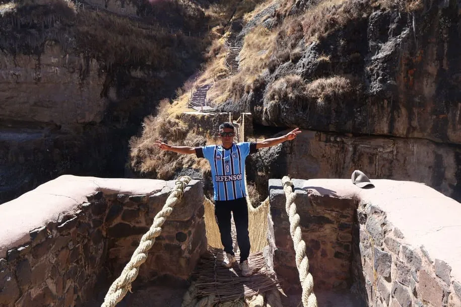 Visitor at the Qeswachaka Inca Bridge near Cusco, Peru, on a cultural day tour.