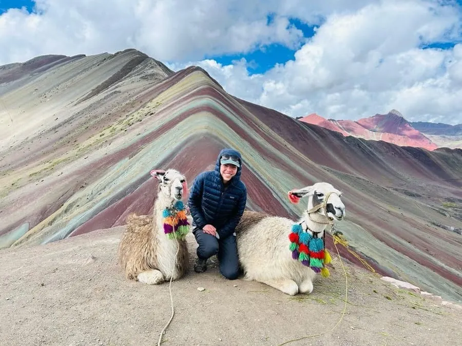 raveler with llamas at Rainbow Mountain Vinicunca on a 1-day tour from Cusco, Peru.