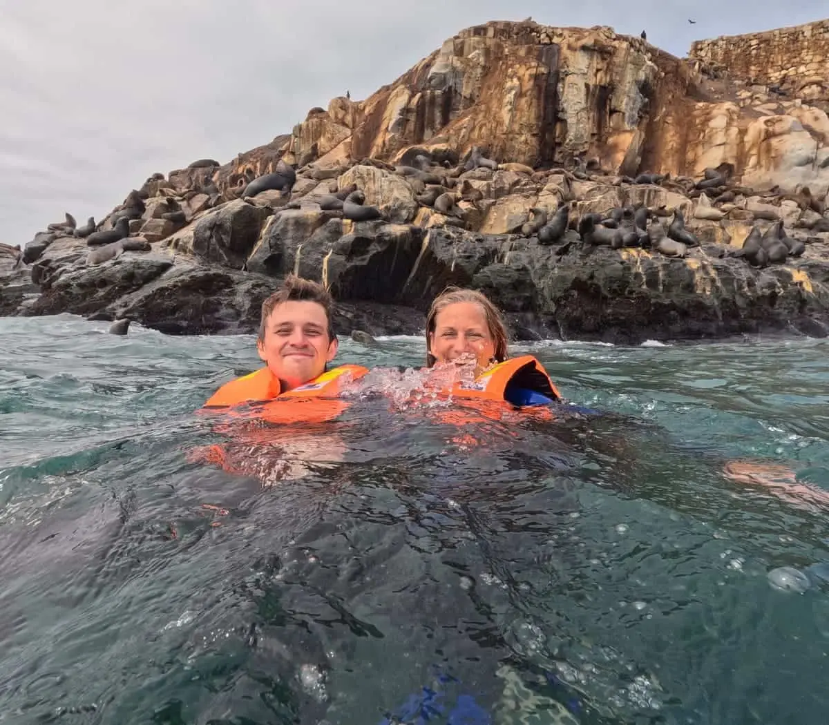 Travelers swimming with sea lions at the Palomino Islands, Peru